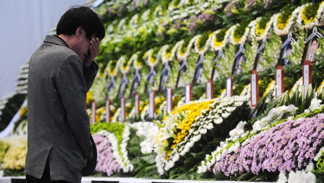A mourner pays tribute to the victims at an altar set up at Ansan Olympic Memorial Hall A mourner pays tribute to the victims at an altar set up at Ansan Olympic Memorial Hall