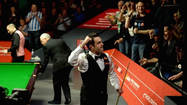 An elated Ronnie O'Sullivan punches the air as he leaves the auditorium following his victory over Joe Perry