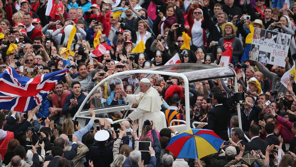 Pope Francis drives through St Peter's Square in the popemobile to meet the crowd