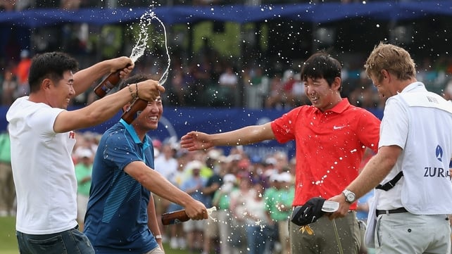 Seung-Yul Noh celebrates with golfers Charlie Wi and YE Yang and his caddy Scott Saitinac after his win
