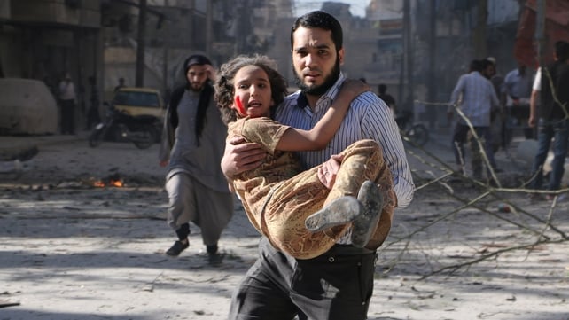 A man carries a wounded girl following an explosion in the northern Syrian city of Aleppo A man carries a wounded girl following an explosion in the northern Syrian city of Aleppo