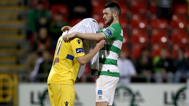 Ryan Brennan helps stand-in keeper Shane Treacy with the goalkeeper's jersey ahead of the injury-time penalty