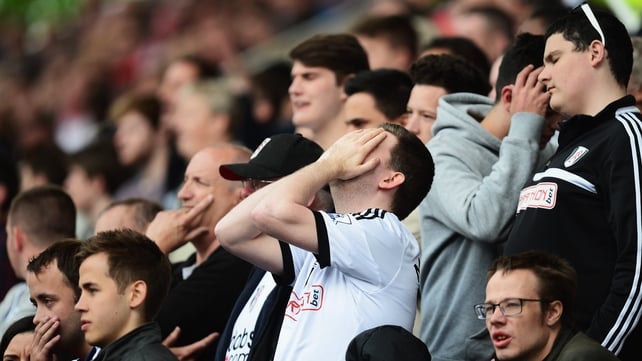 Fulham fans react as their side slumps to a relegation-ensuring defeat