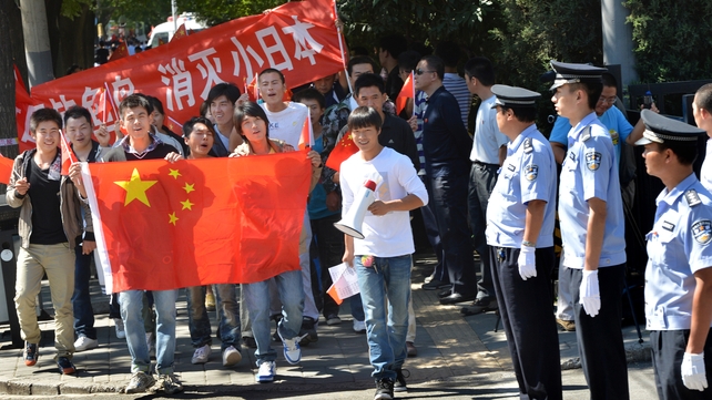 Anti-Japanese demonstrators march with the Chinese flag in a protest outside the Japanese Embassy in recent years Anti-Japanese demonstrators march with the Chinese flag in a protest outside the Japanese Embassy in recent years