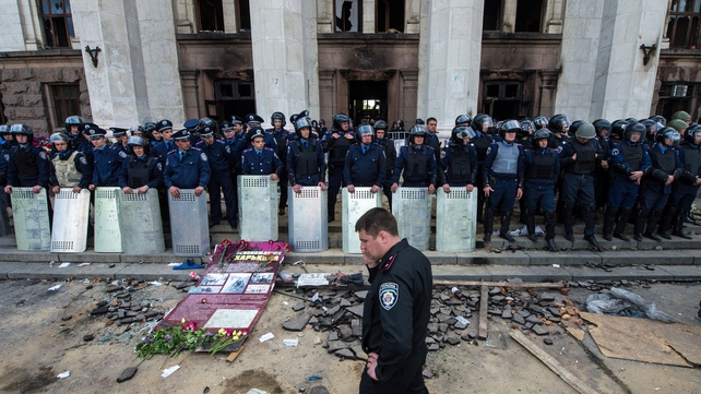 Policemen stand guard outside the charred trade union building in the southern Ukrainian city of Odessa Policemen stand guard outside the charred trade union building in the southern Ukrainian city of Odessa