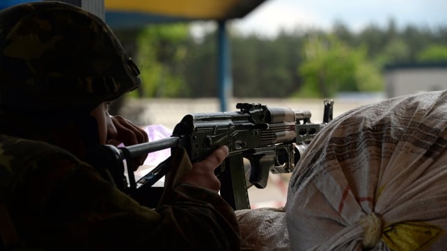 A Ukrainian soldier holds a position at a checkpoint near Slaviansk A Ukrainian soldier holds a position at a checkpoint near Slaviansk