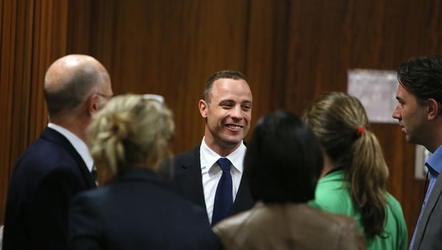 Oscar Pistorius talks to relatives and friends in the high court in Pretoria Oscar Pistorius talks to relatives and friends in the high court in Pretoria