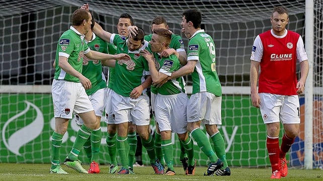 Mark O'Sullivan of Cork celebrates scoring the first goal with teammates as Kenny Browne of Pat's is dejected