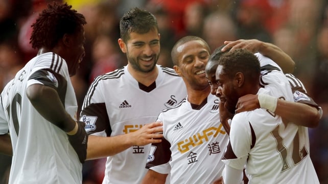 Marvin Emnes celebrates with his team-mates after scoring Swansea's second goal