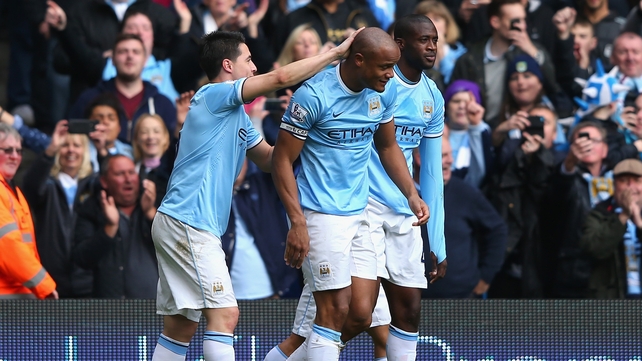 Vincent Kompany is congratulated by his team-mates after scoring the second goal against West Ham
