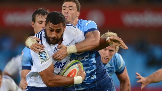 Patrick Tuipulotu of the Blues is tackled by Bjorn Basson of the Bulls during a Super Rugby match