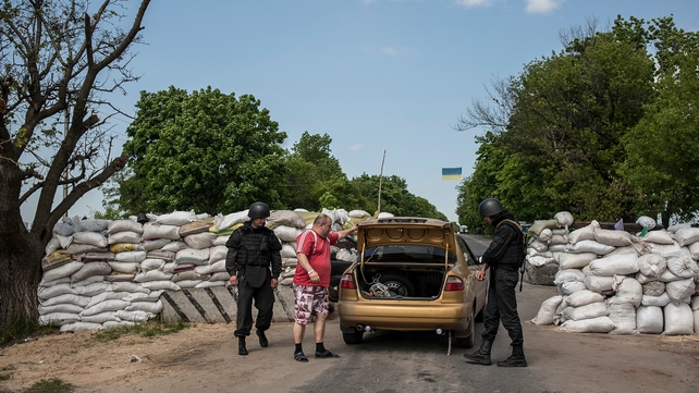 Ukrainian soldiers check a car at a checkpoint not far from Slaviansk, Ukraine Ukrainian soldiers check a car at a checkpoint not far from Slaviansk, Ukraine