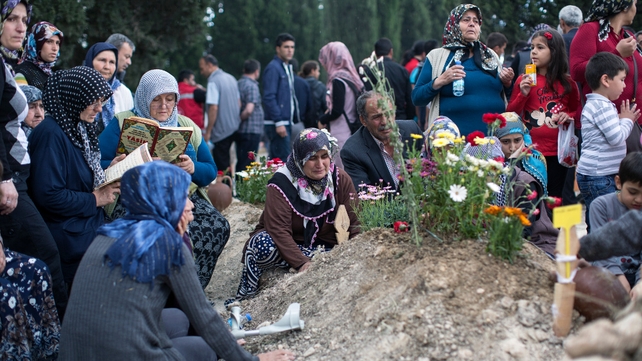 Relatives gather at the grave of one of the miners killed in the disaster Relatives gather at the grave of one of the miners killed in the disaster