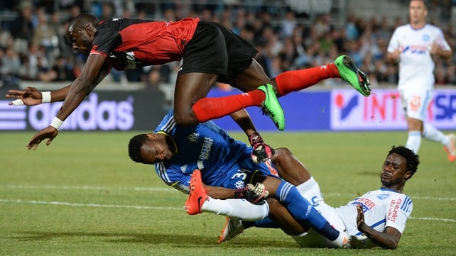 Guingamp striker Mustapha Yatabare collides with Marseille keeper Steve Mandanda