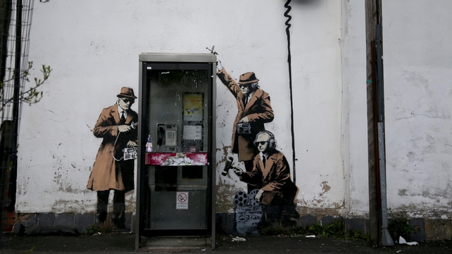 The creation shows three 1950s-style agents, wearing brown trench coats and trilby hats The creation shows three 1950s-style agents, wearing brown trench coats and trilby hats