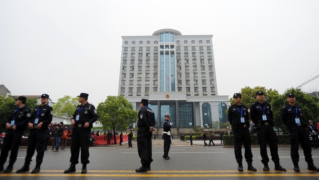 Police stand guard outside the Xianning Intermediate People's Court Police stand guard outside the Xianning Intermediate People's Court