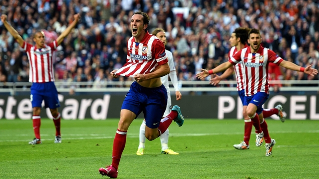 Diego Godin celebrates scoring the game's opening goal
