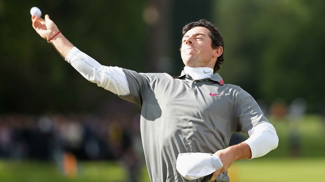 Rory McIlroy throws his ball to the spectators after his birdie on 18