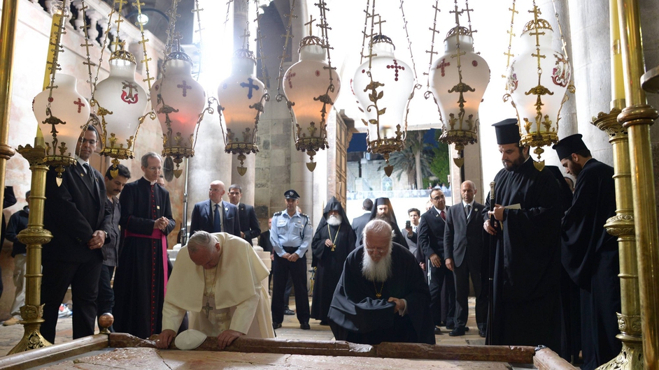 Pope Francis worships at the Stone of Anointing at the Church of the Holy Sepulchre in Jerusalem