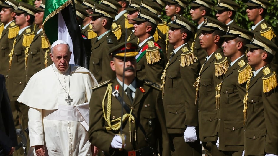Pope Francis inspects an honour guard upon his arrival to the West Bank