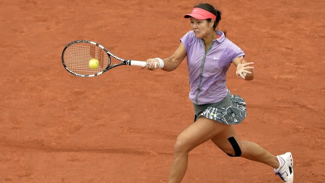 Li Na stretches to return a shot against Kristina Mladenovic during their first-round French Open match