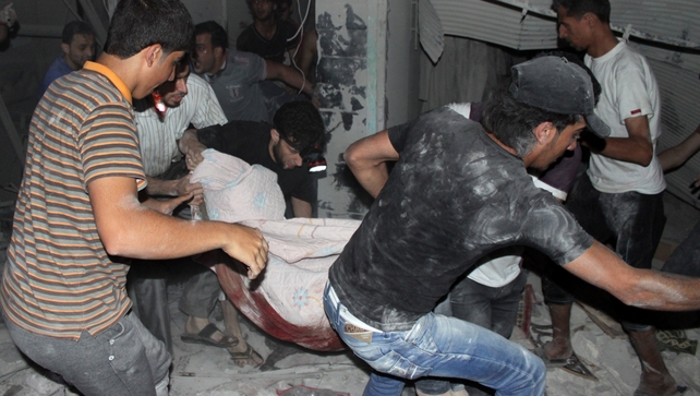 Men carry a body from a destroyed building after shelling during the night on the northern Syrian city of Aleppo Men carry a body from a destroyed building after shelling during the night on the northern Syrian city of Aleppo