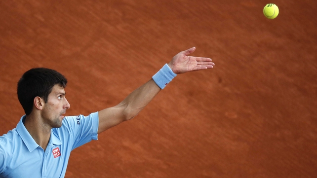 Novak Djokovic serves to France's Jeremy Chardy during their French tennis Open second round match