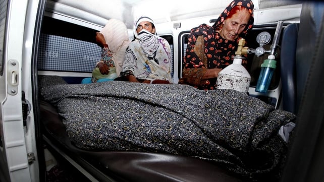 Relatives transport the body of Farzana Iqbal who was beaten to death on Tuesday Relatives transport the body of Farzana Iqbal who was beaten to death on Tuesday