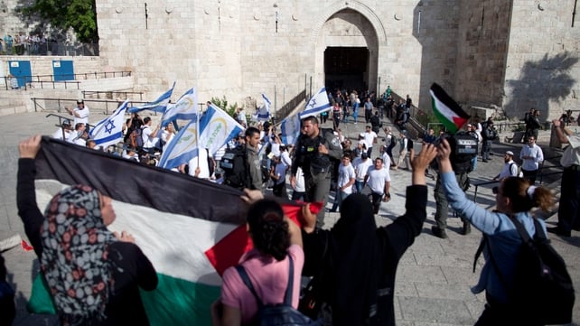 Palestinian protesters stand in front of Israelis with flags marking Jerusalem Day Palestinian protesters stand in front of Israelis with flags marking Jerusalem Day
