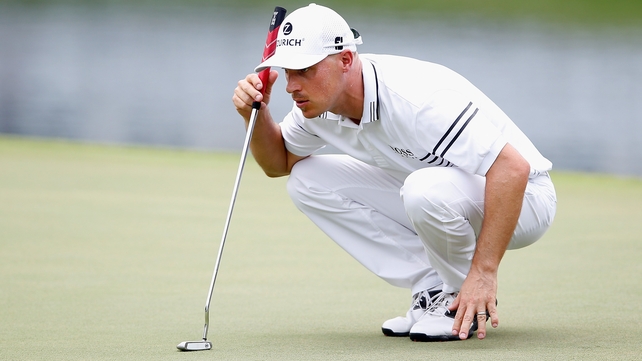 Ben Crane lines up a putt on the 18th green during the second round