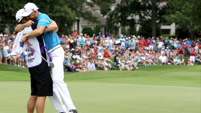 Ben Crane celebrates with his caddie Joel Stock on the 18th green after sealing his win