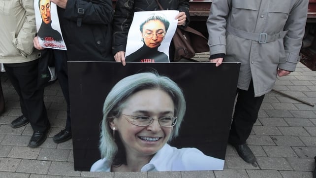 People hold photos as they attend a commemoration rally in honour Anna Politkovskaya in 2012 People hold photos as they attend a commemoration rally in honour Anna Politkovskaya in 2012