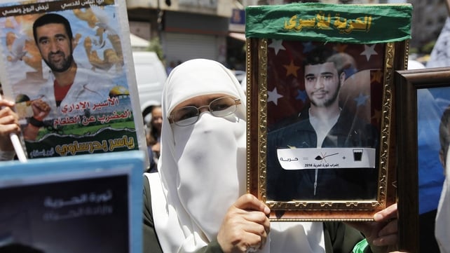 A Palestinian woman holds a portrait of a detainee in the West Bank city of Ramallah A Palestinian woman holds a portrait of a detainee in the West Bank city of Ramallah