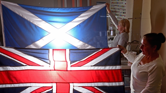 Members of staff at James Stevenson Flags hold a Union Jack and Saltire flag in Glasgow Members of staff at James Stevenson Flags hold a Union Jack and Saltire flag in Glasgow