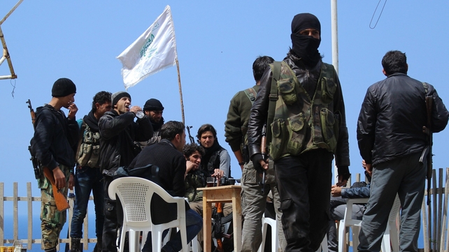 Rebel fighters from the Ansar al-Sham brigade hold a position on a ridge overlooking the Mediterranean sea reportedly in the village of Kasab Rebel fighters from the Ansar al-Sham brigade hold a position on a ridge overlooking the Mediterranean sea reportedly in the village of Kasab