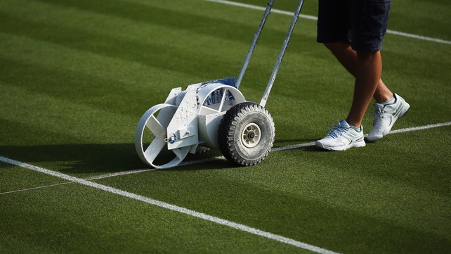 A groundsman marks the lines