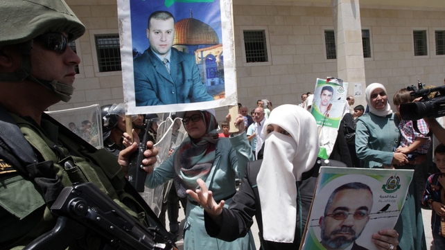 A Palestinian woman gestures to a member of Palestinian security forces after protesters were asked to stop a demonstration to express solidarity with prisoners on hunger strike A Palestinian woman gestures to a member of Palestinian security forces after protesters were asked to stop a demonstration to express solidarity with prisoners on hunger strike