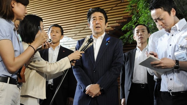 Japanese Prime Minister Shinzo Abe (C) speaks to reporters at his official residence in Tokyo Japanese Prime Minister Shinzo Abe (C) speaks to reporters at his official residence in Tokyo