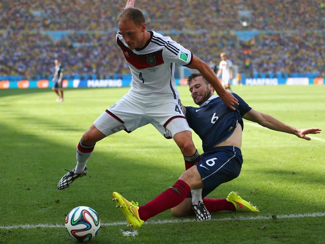 Yohan Cabaye (R) tackles Germany's Benedikt Hoewedes