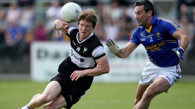 David Kelly of Sligo attempts to break free from the attention of Wicklow's Ciaran Hyland
