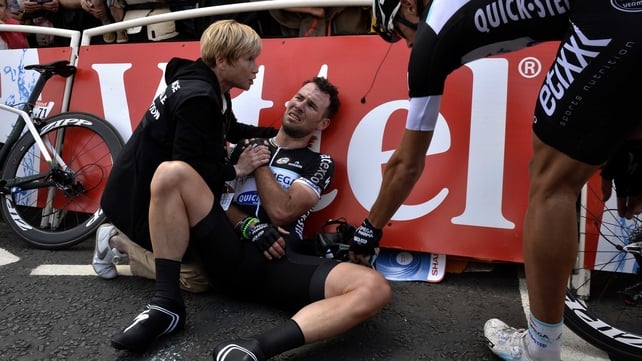 Mark Cavendish receives medical assistance after his fall