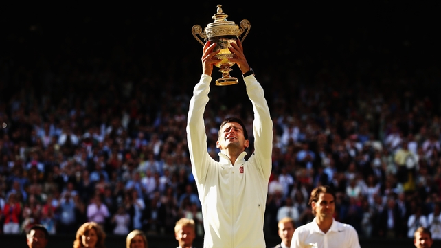 Novak Djokovic holds the winner's trophy aloft