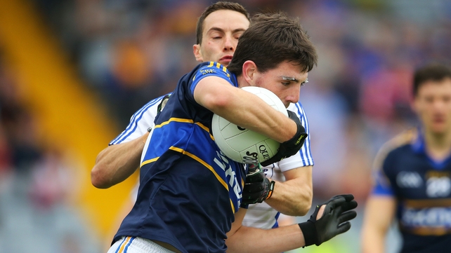Laois' Niall Donoher tackles Colin O'Riordan of Tipperary
