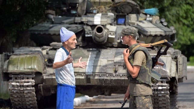 A local resident talks with a Ukrainian in Seversk, one day after the town was freed from pro-Russian militants A local resident talks with a Ukrainian in Seversk, one day after the town was freed from pro-Russian militants