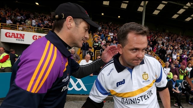 Wexford manager Liam Dunne commiserates with Davy Fitzgerald (R) after the game.