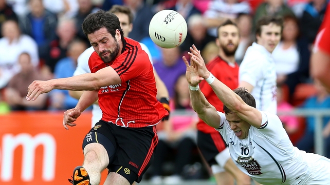 Down's Kevin McKernan gets his shot past Shane Connolly's diving block attempt