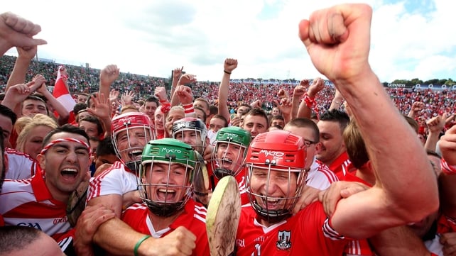 Cork players and fans celebrate on the Páirc Uí Chaoimh turf