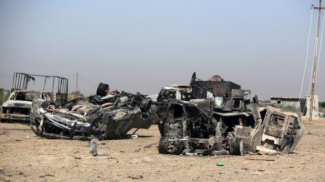 Burned and destroyed Iraq military vehicles are seen on a road in the town of Samarra Burned and destroyed Iraq military vehicles are seen on a road in the town of Samarra