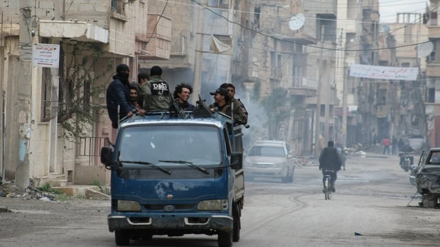 Rebels stand on the back of a pick-up truck driving through the eastern Syrian town of Deir Ezzor in March Rebels stand on the back of a pick-up truck driving through the eastern Syrian town of Deir Ezzor in March