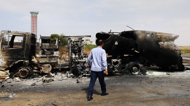 The wreckage of a truck and an airplane are seen at Tripoli international airport in the Libyan capital The wreckage of a truck and an airplane are seen at Tripoli international airport in the Libyan capital